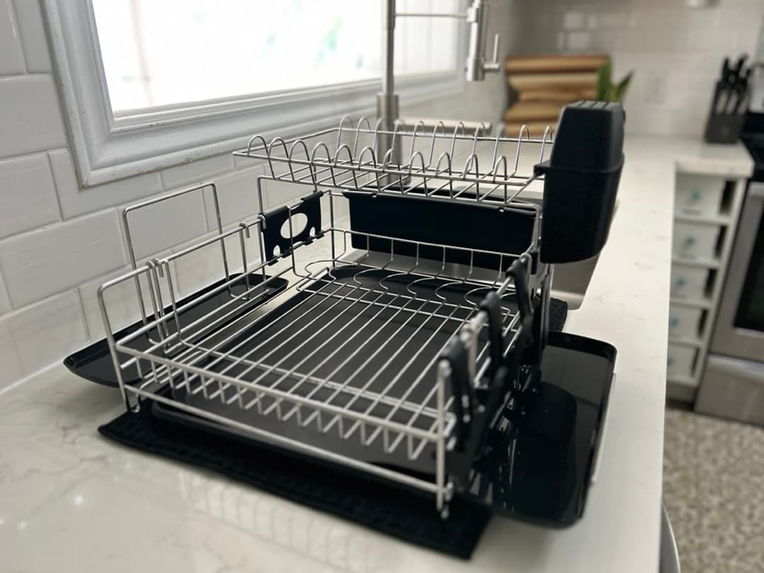 Dish drying rack beside a kitchen sink