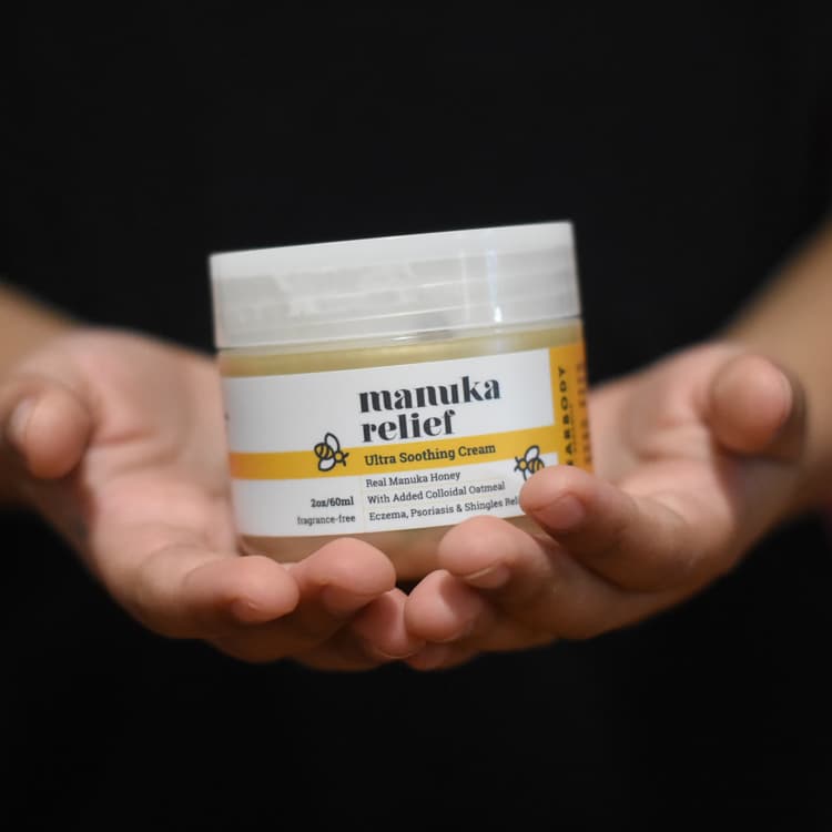 Manuka cream held in a pair of hands